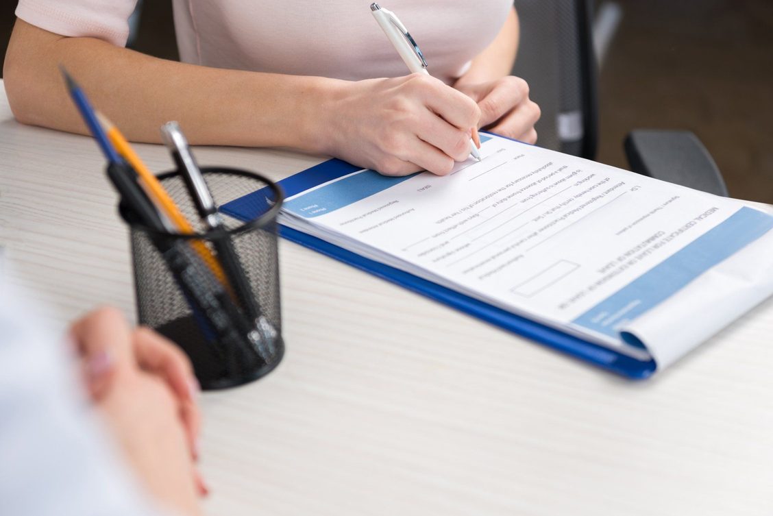 A patient completing a medical request form